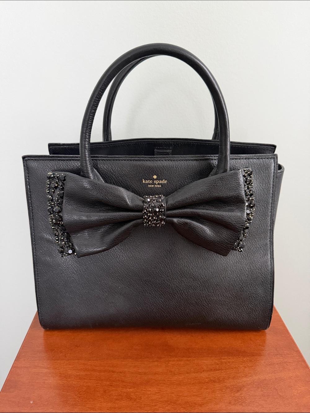kate spade black leather satchel with jeweled bow